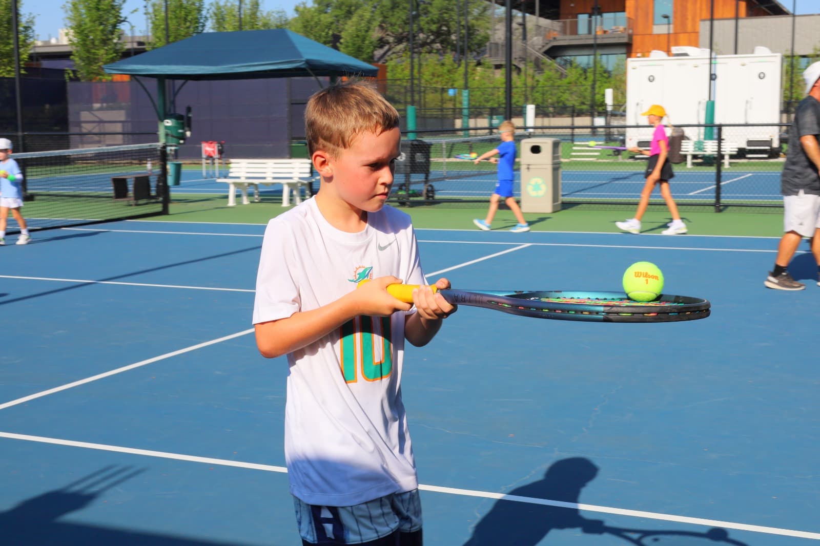 Kid hitting a tennis ball
